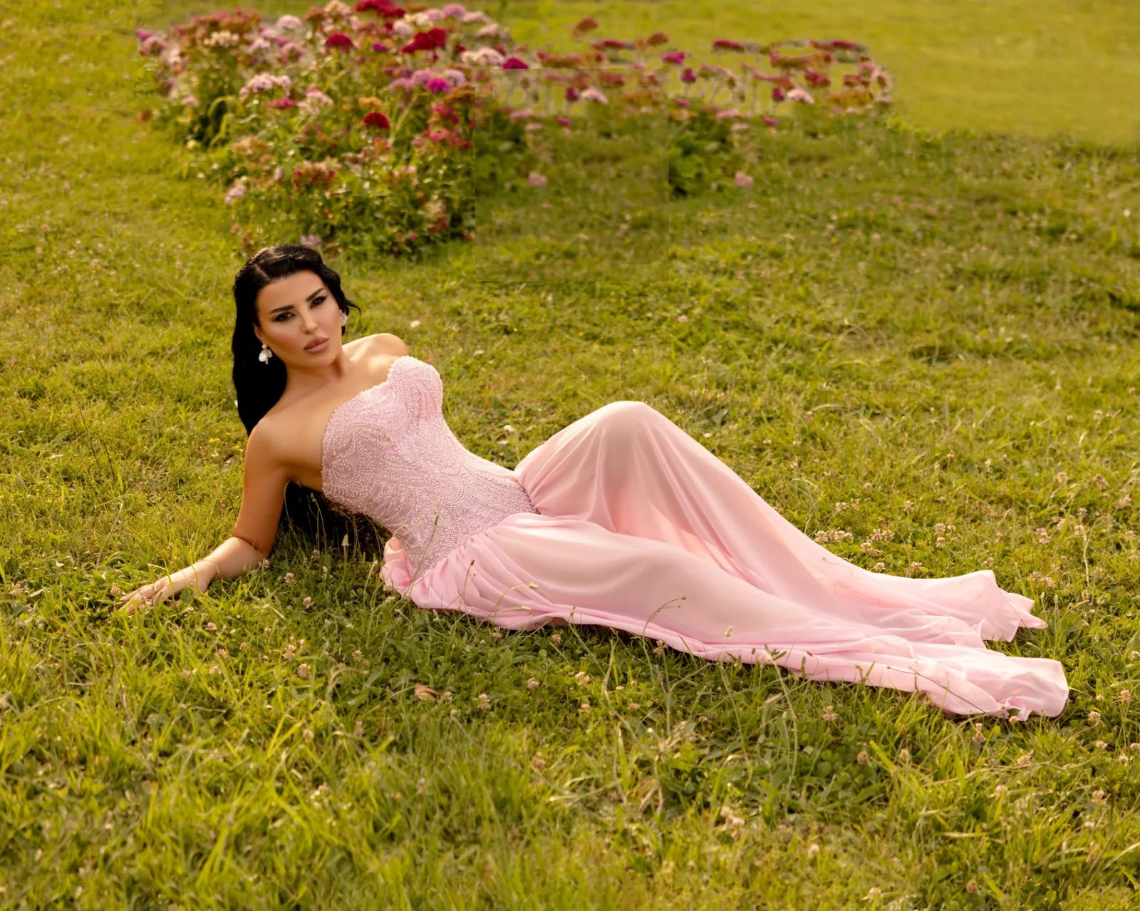 Barzezzi blush pink beaded gown photographed in a flowering summer garden